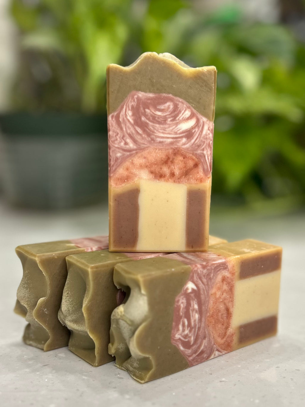 Stack of mushroom designed soap bars with a blurred plant in the background