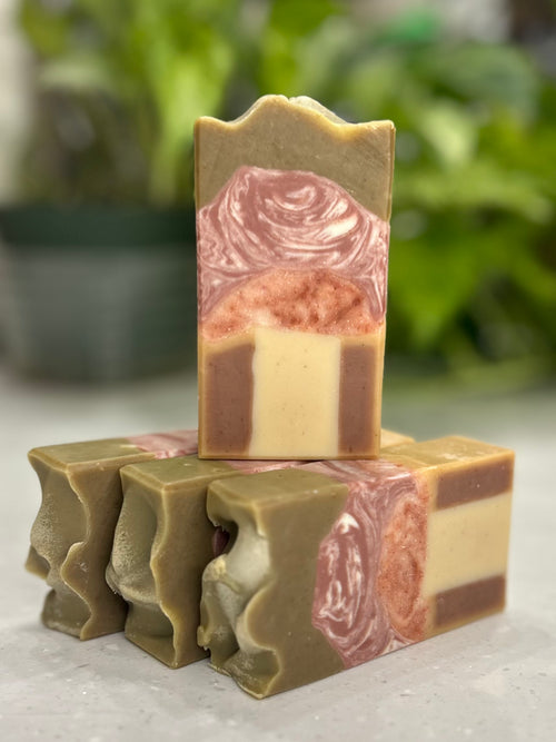 Stack of mushroom designed soap bars with a blurred plant in the background