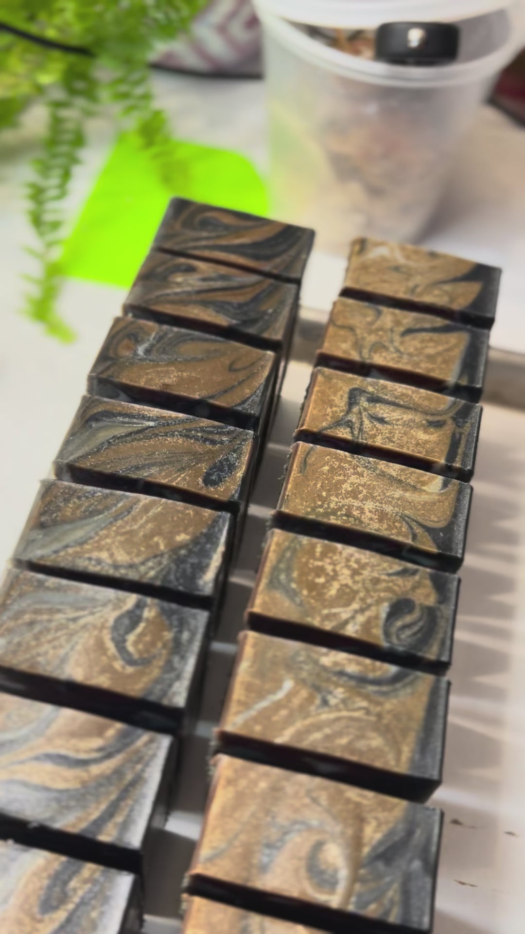 Video of rows of cut bars of handmade soap on a white countertop.